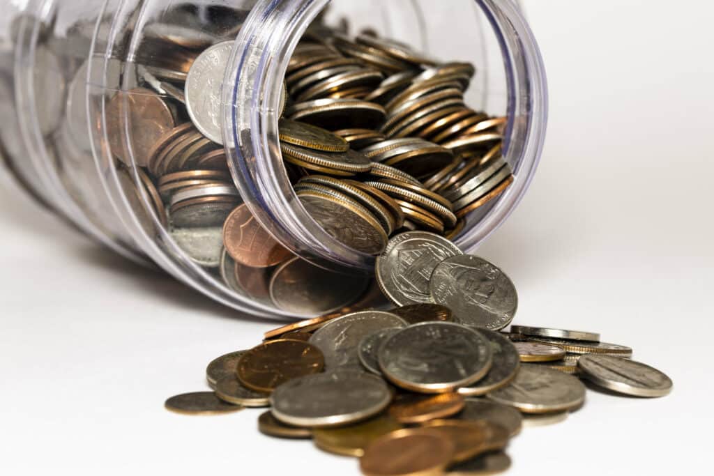 Change spilling out of a jar as a symbol of saving for retirement