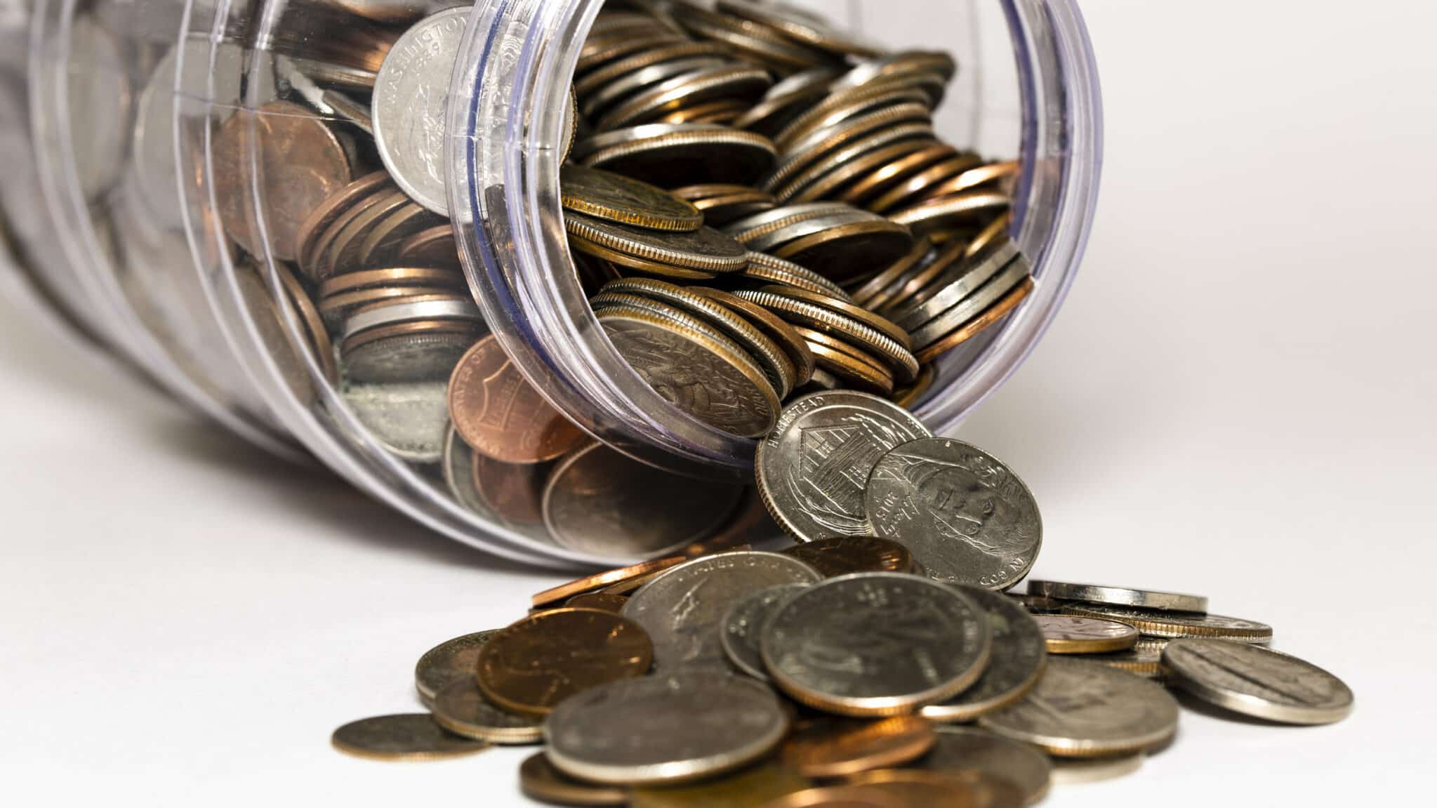Change spilling out of a jar as a symbol of saving for retirement