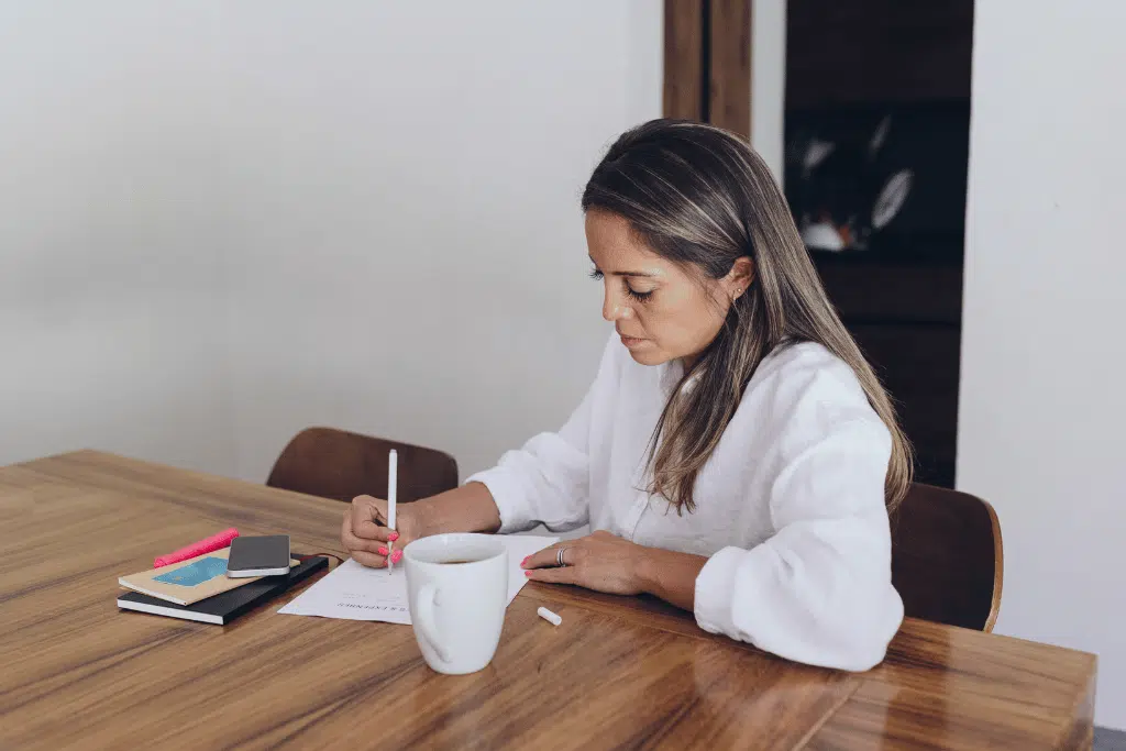 Young woman tracking her expenses and celebrating a small savings win