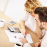 Couple managing their finances and finding debt relief solutions together.