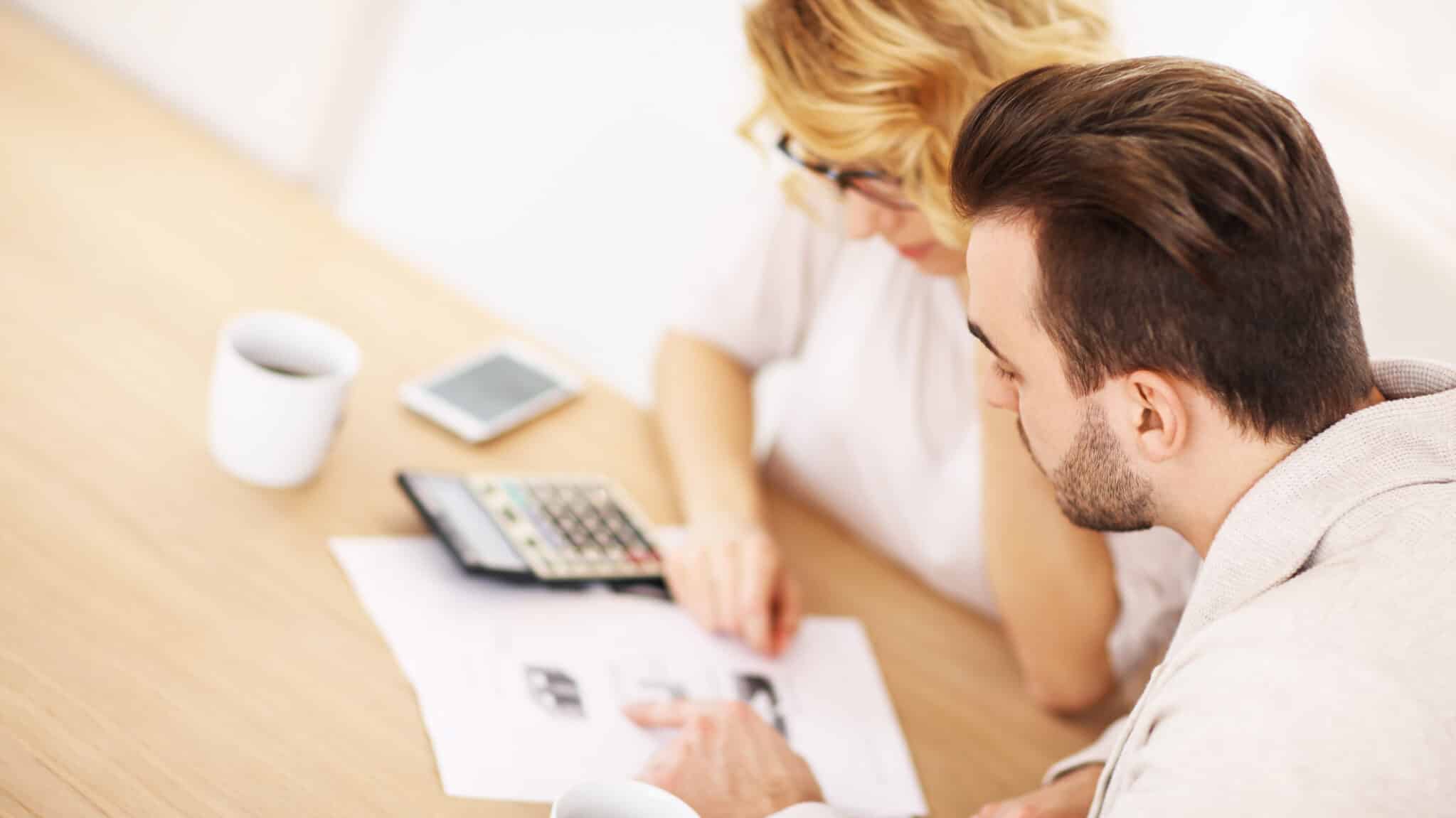 Couple managing their finances and finding debt relief solutions together.