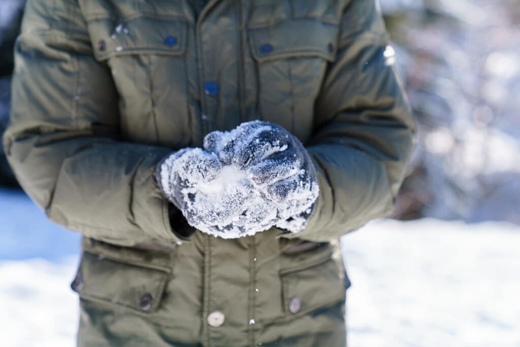 man preparing a snowball to throw