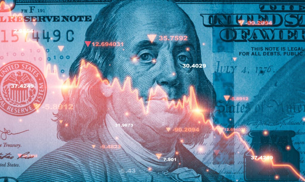 Hundred dollar bill with stock market chart overlay indicating downward trend