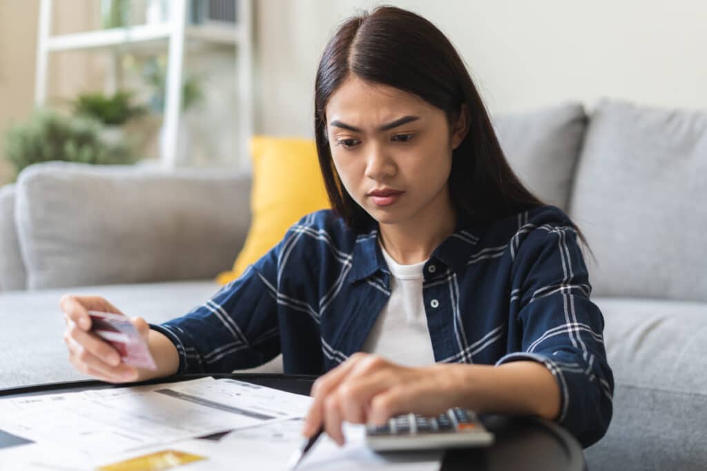 Young woman figuring out credit card payments