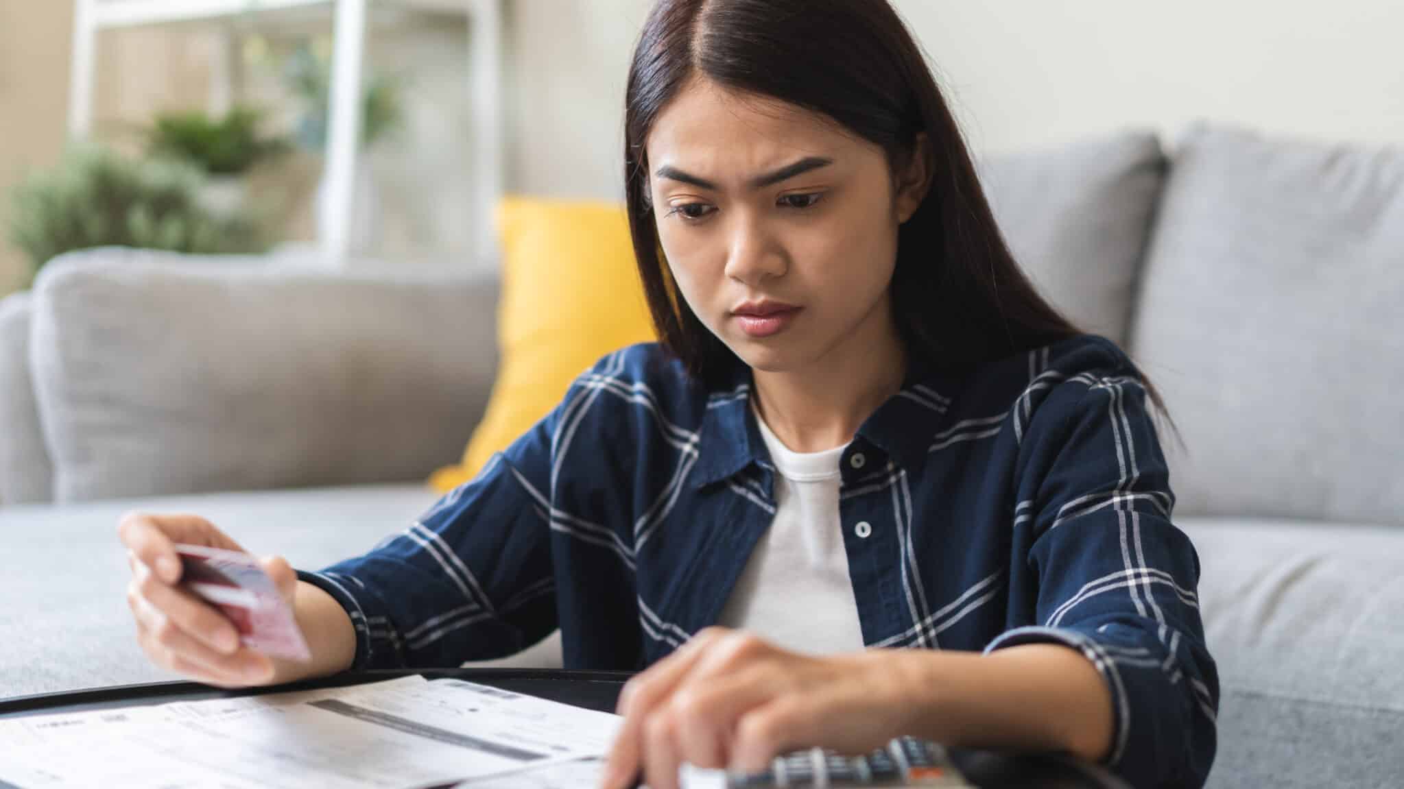 Young woman figuring out credit card payments