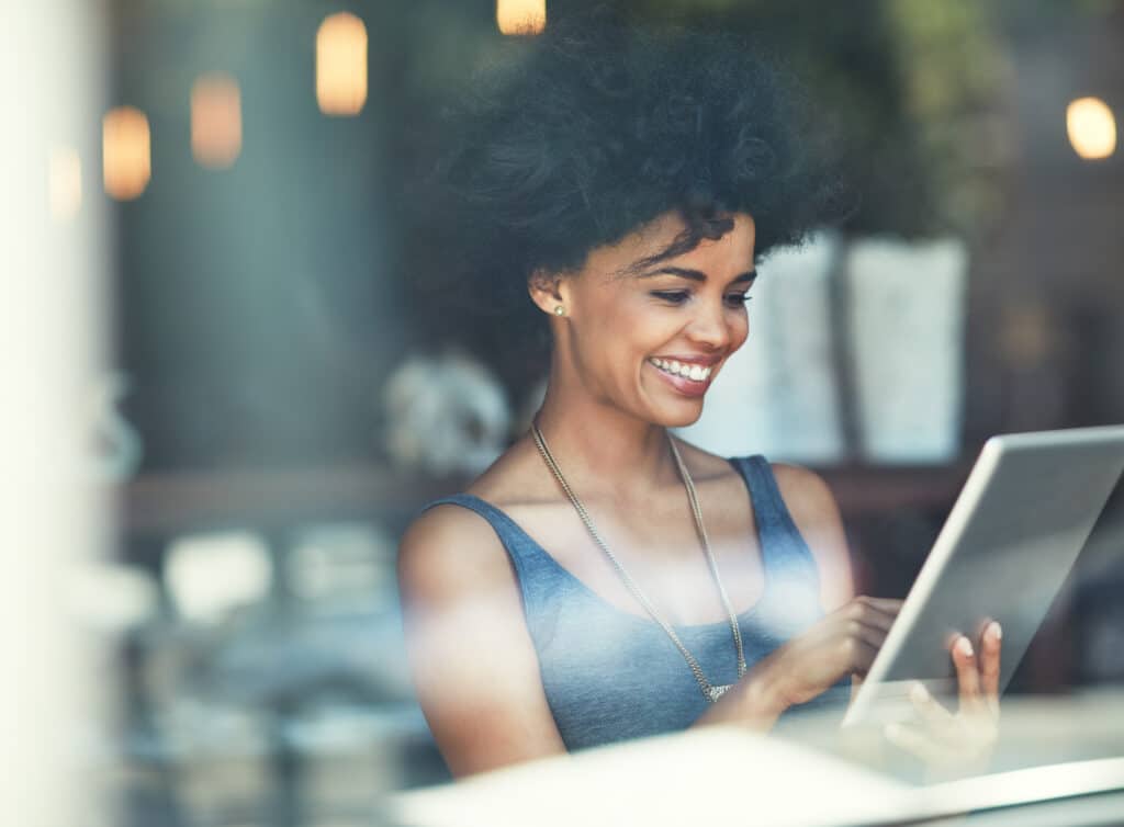 woman happy, content and paying bills in a coffee shop