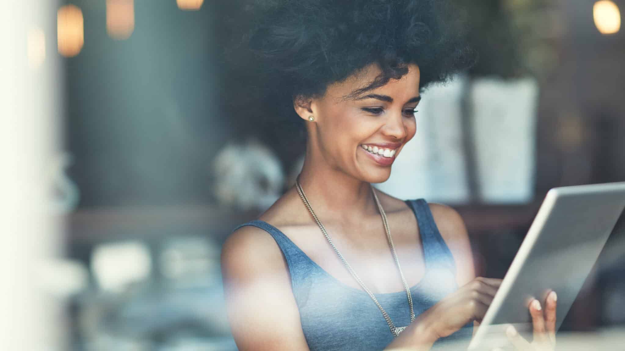 woman happy, content and paying bills in a coffee shop