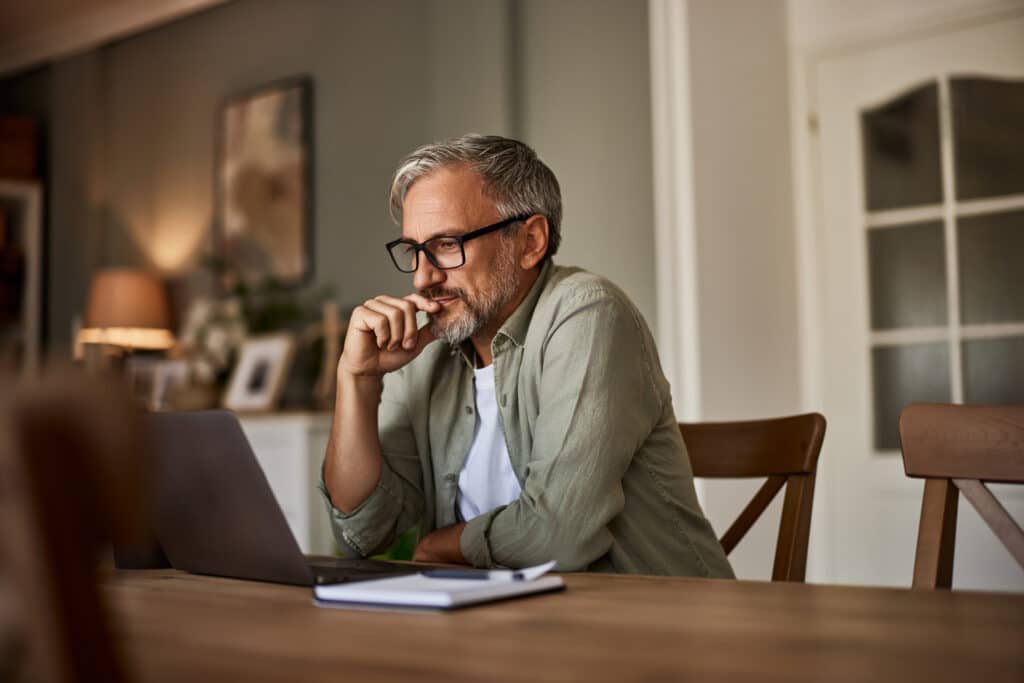 Man reading credit card articles online