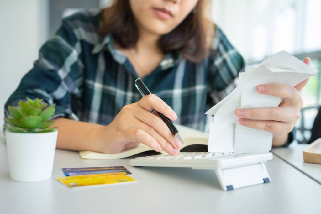 woman assessing credit card debt wondering how it affects her credit score