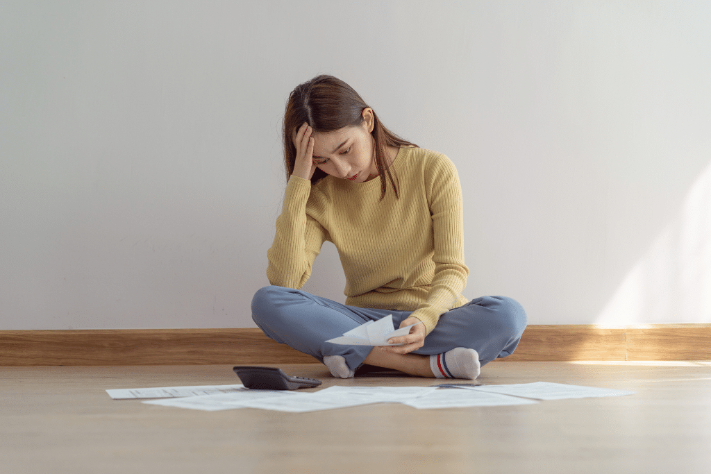 woman reviewing bills and always feeling broke