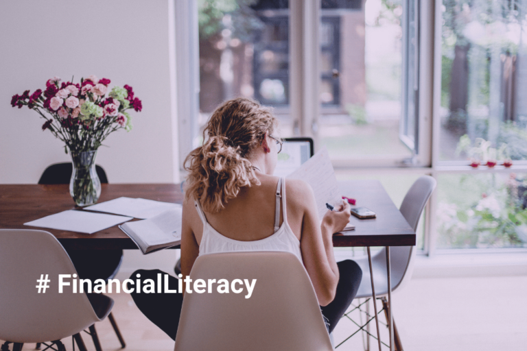 financial literacy month april 2026 woman studying finances at home