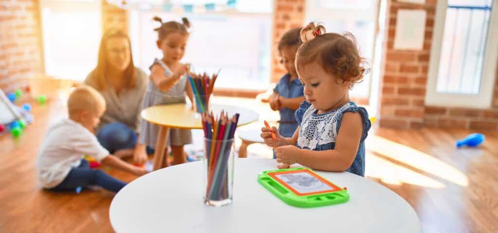 four kids learning at a childcare in idaho with one teacher