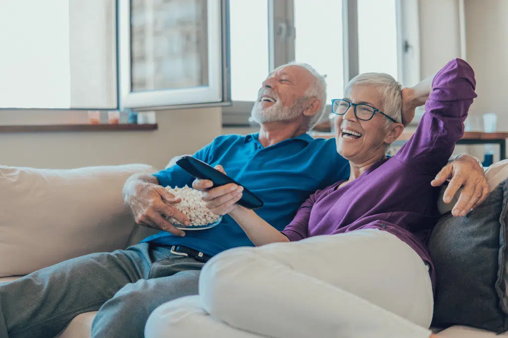 Older couple at home relaxing together on a couch