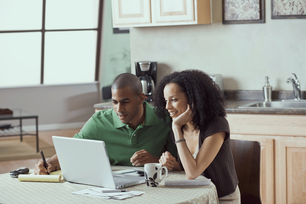 Couple reviewing credit card relief options together on a laptop at home