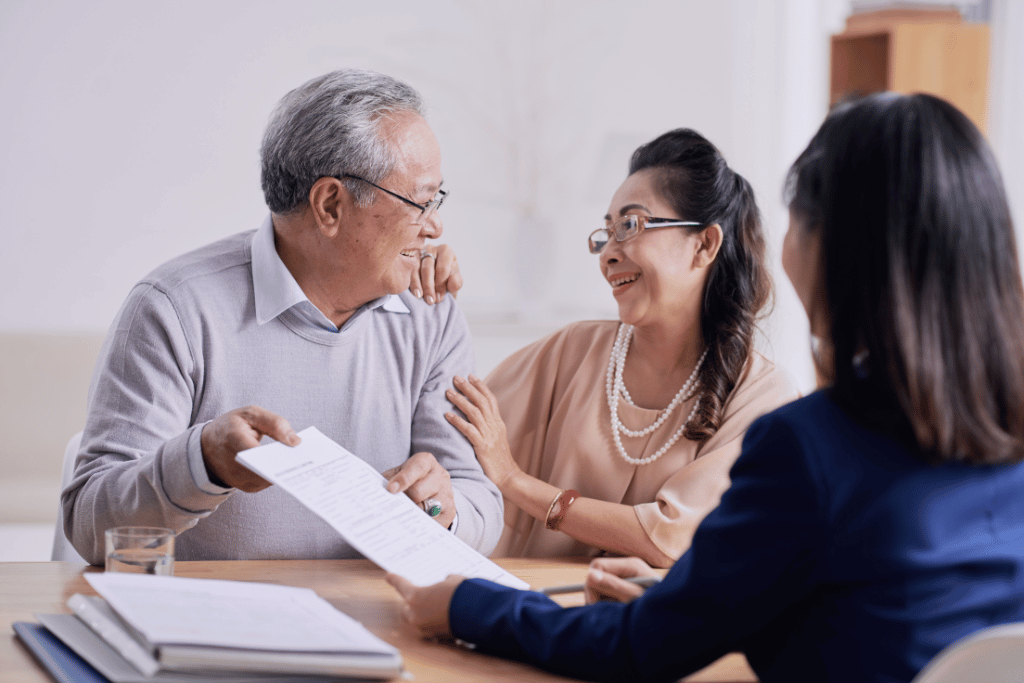 Couple meeting with a counselor to review debt and housing-related expenses.