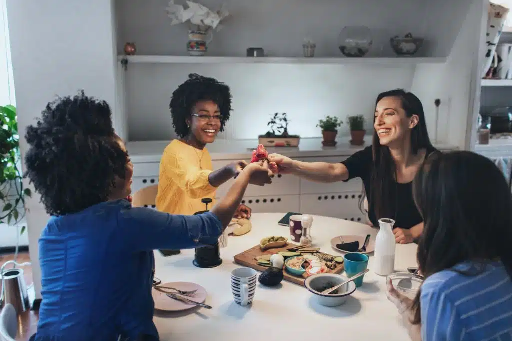 Four roommates dining together and having a good time