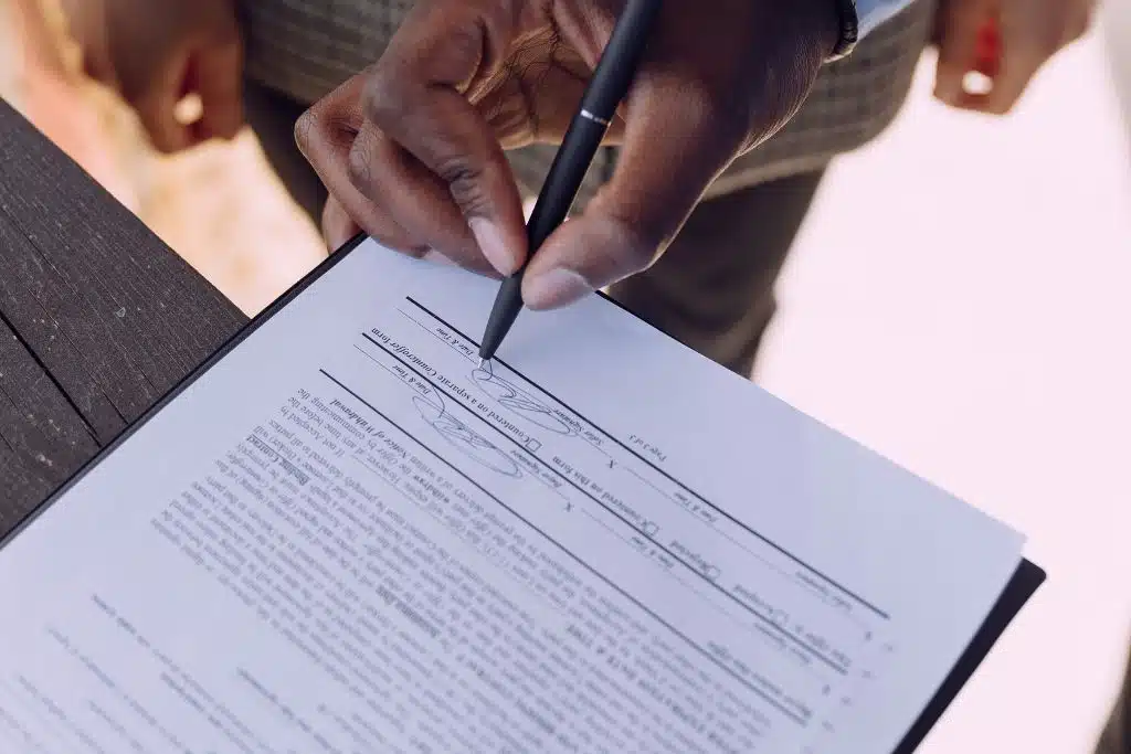 Man reviewing his loan terms and signing the final documents