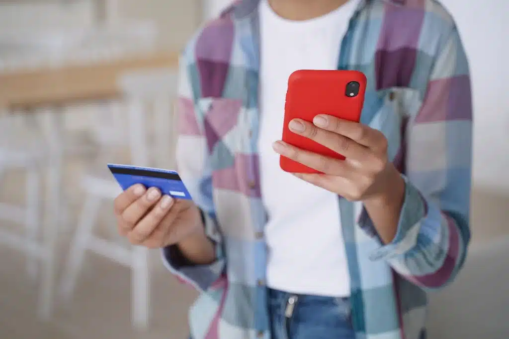 Woman managing her money with a mobile banking app at home