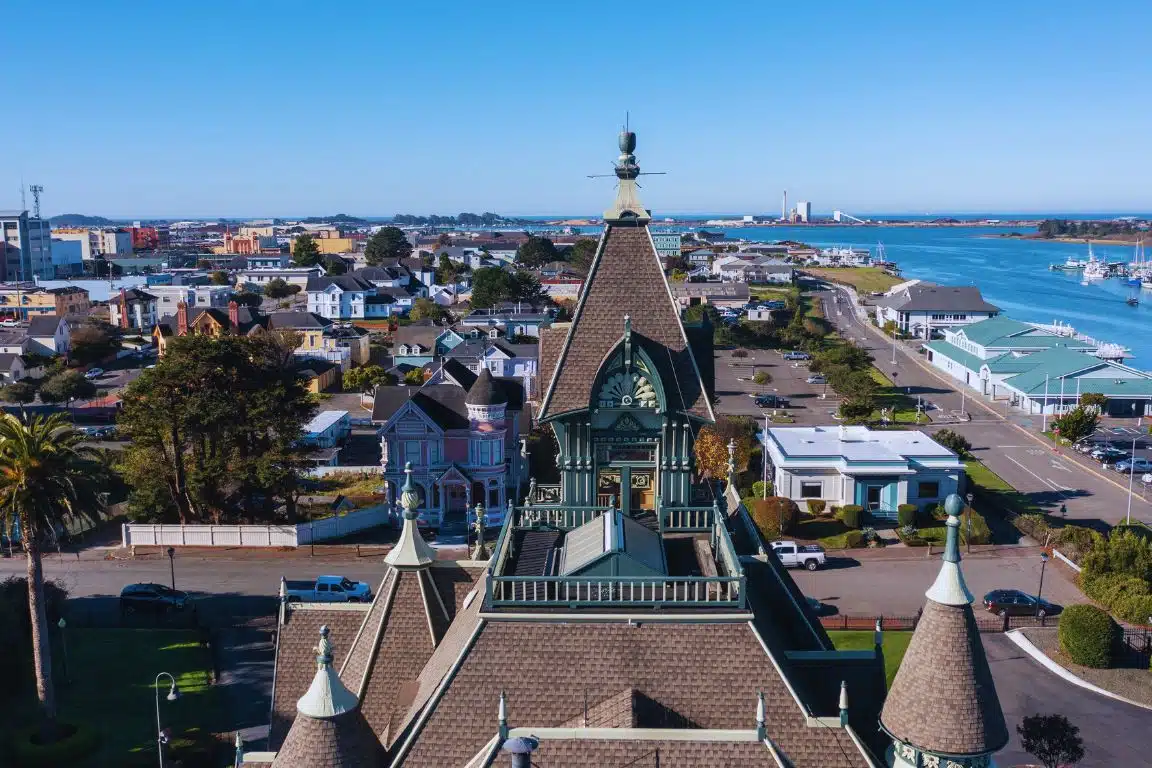 Carson Mansion in Eureka, California, with Victorian architecture overlooking Humboldt Bay and surrounding cityscape.