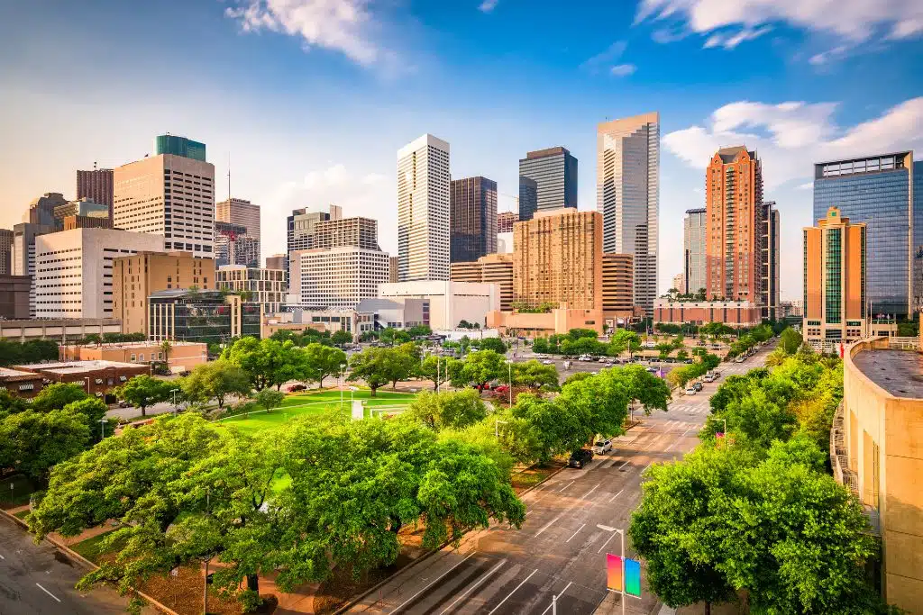 Vibrant daytime view of the Houston skyline with a park in the foreground