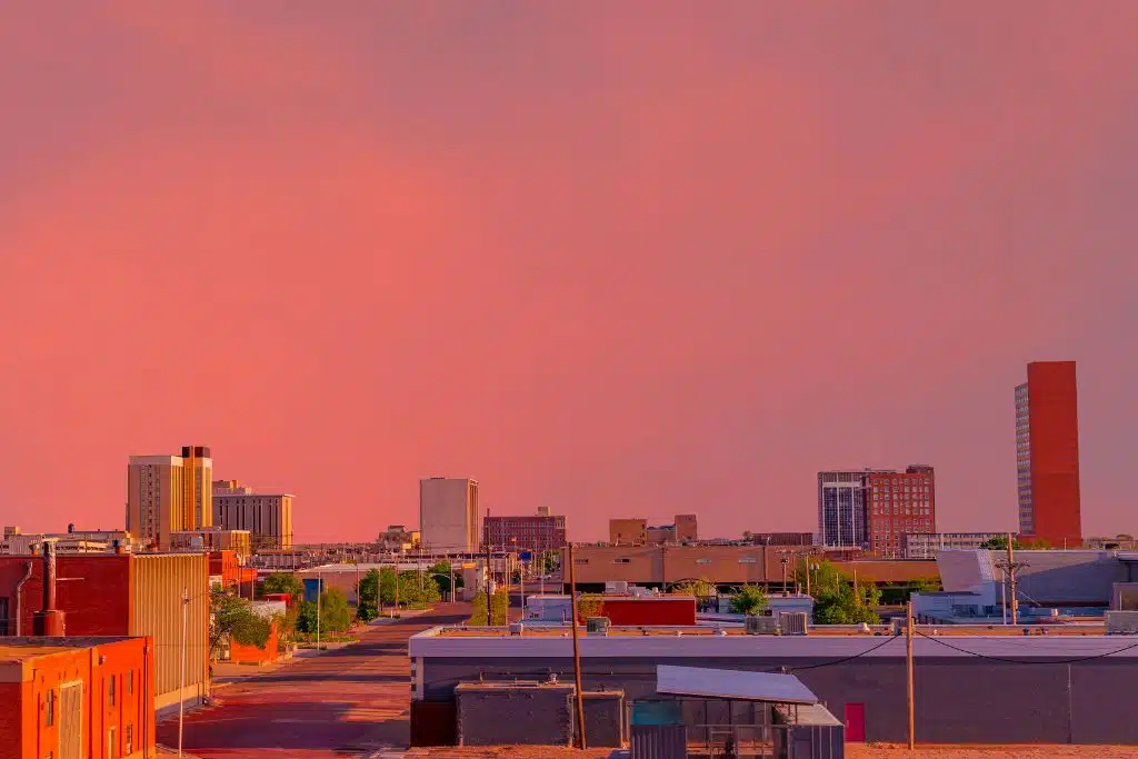 Vibrant pink and magenta sky over the Lubbock skyline at dusk