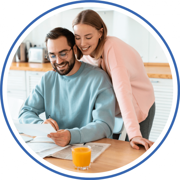 a couple at home on a laptop working together finding help for their credit cards
