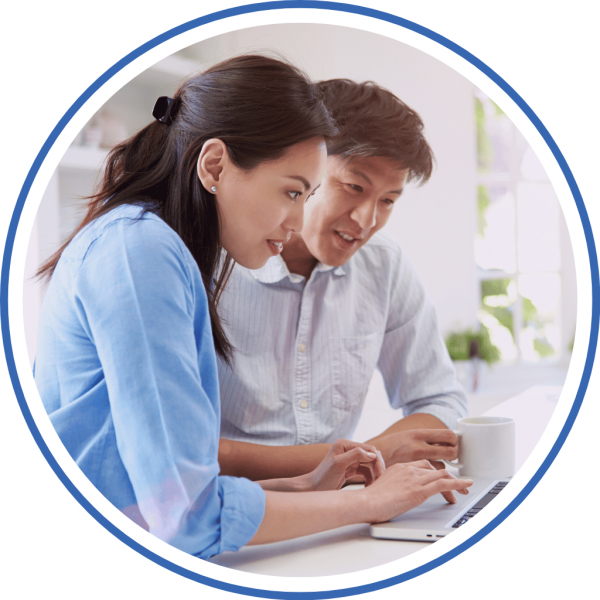 a couple browsing the internet on their laptop as they seek help for their high credit card debt