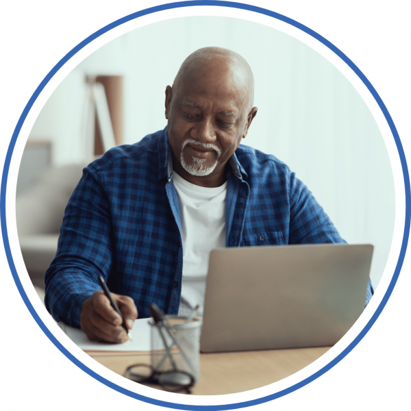 a man at home looking on his laptop for options to pay off his mounting credit card debt