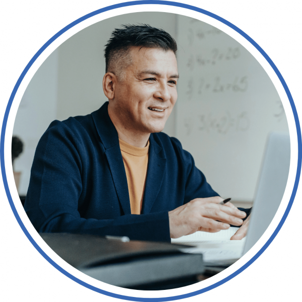 a man smiling while on his laptop happy he found money fit to help with his credit card debt