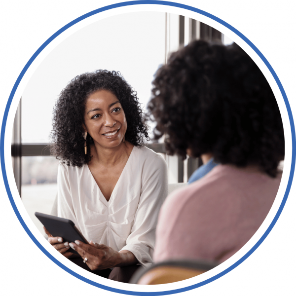 a woman speaking with a credit counselor to consolidate her debt and improve her finances