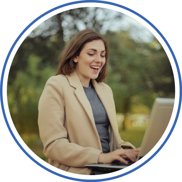 woman happy on a laptop reviewing her payment progress on credit one debt relief program
